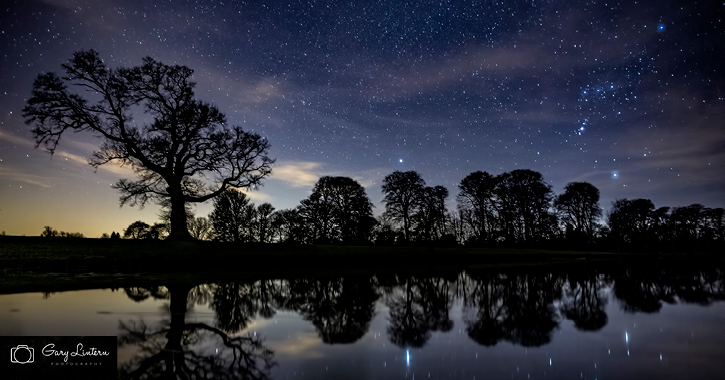 Starry night sky overlooking Raby Castle Lake copywrite Gary Lintern